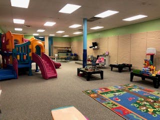 Indoor play area with colorful slides and play structures