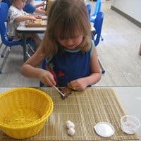 Child working on a craft at a table
