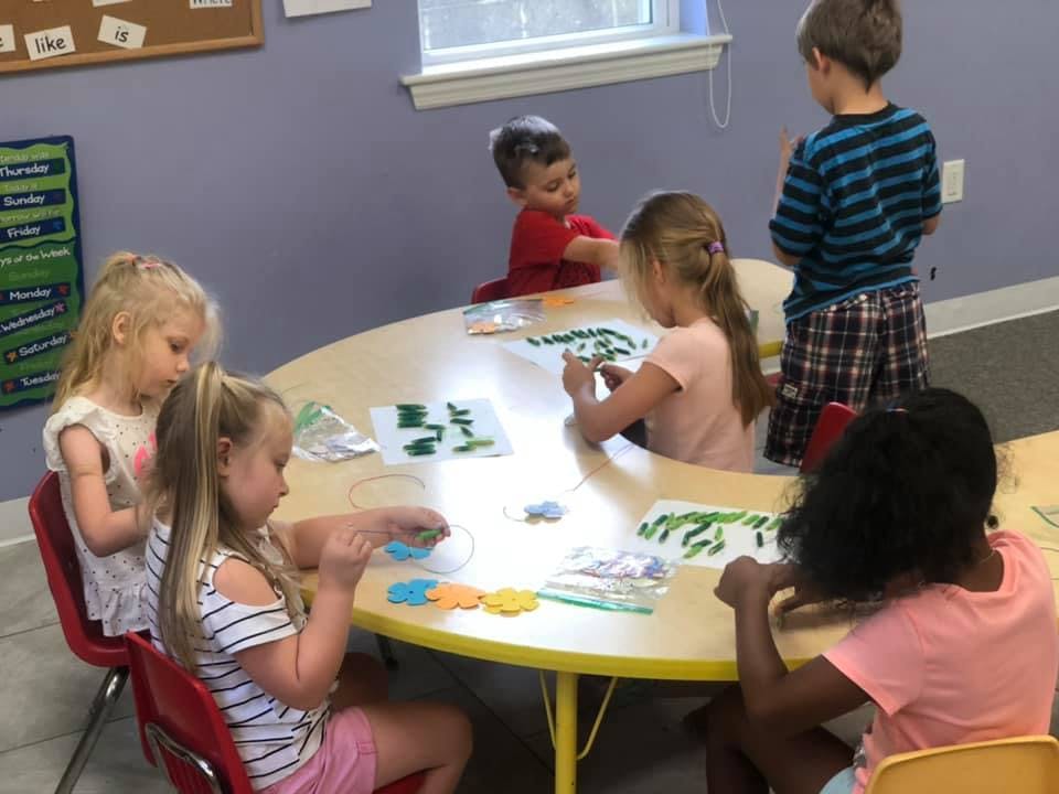 Children sitting around a table doing an activity