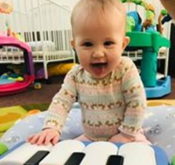 Child playing with a toy piano
