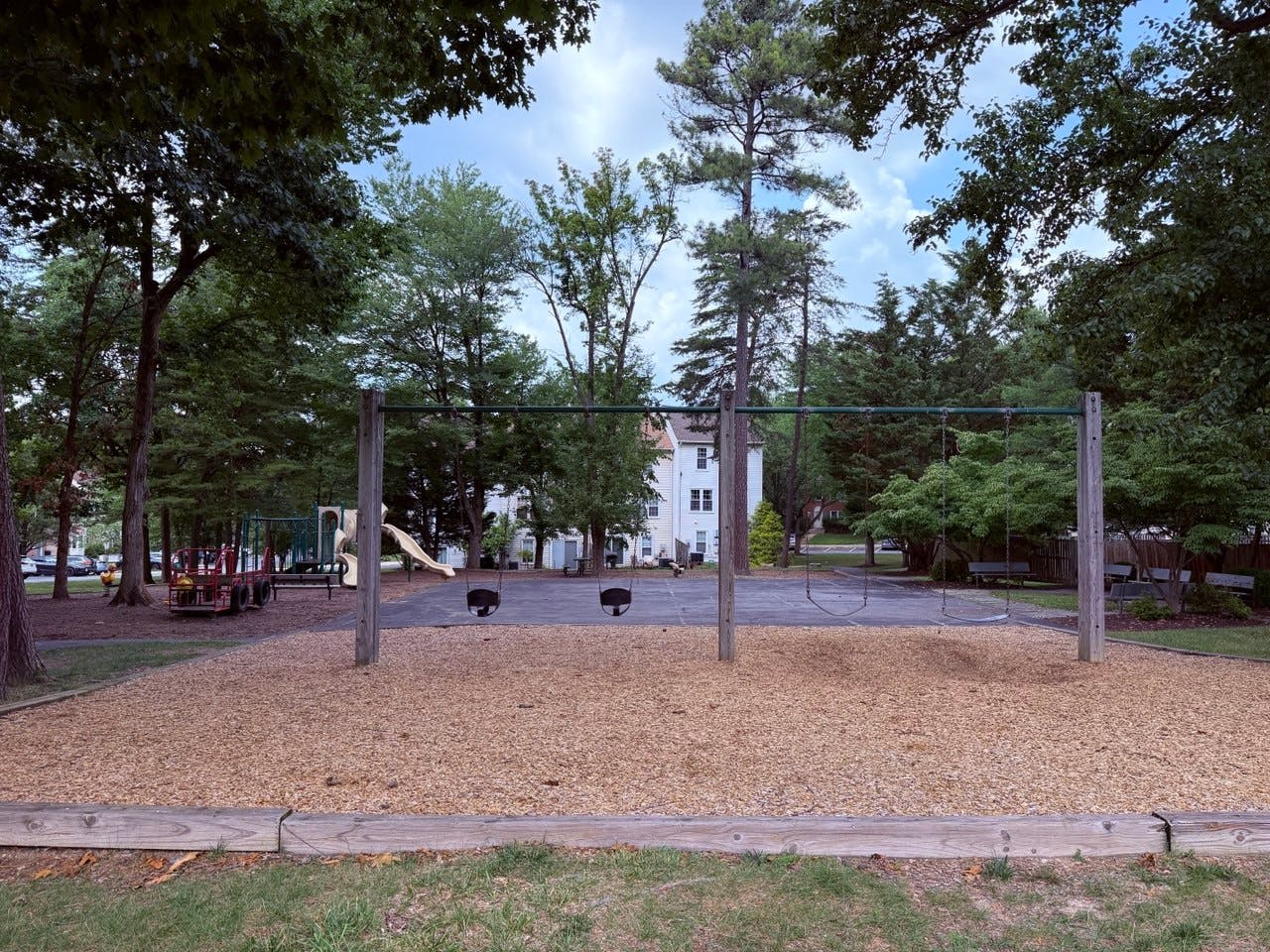 Empty swings at a playground in a park