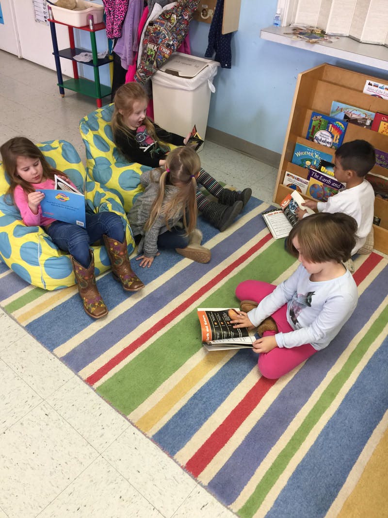 Children reading books in a classroom