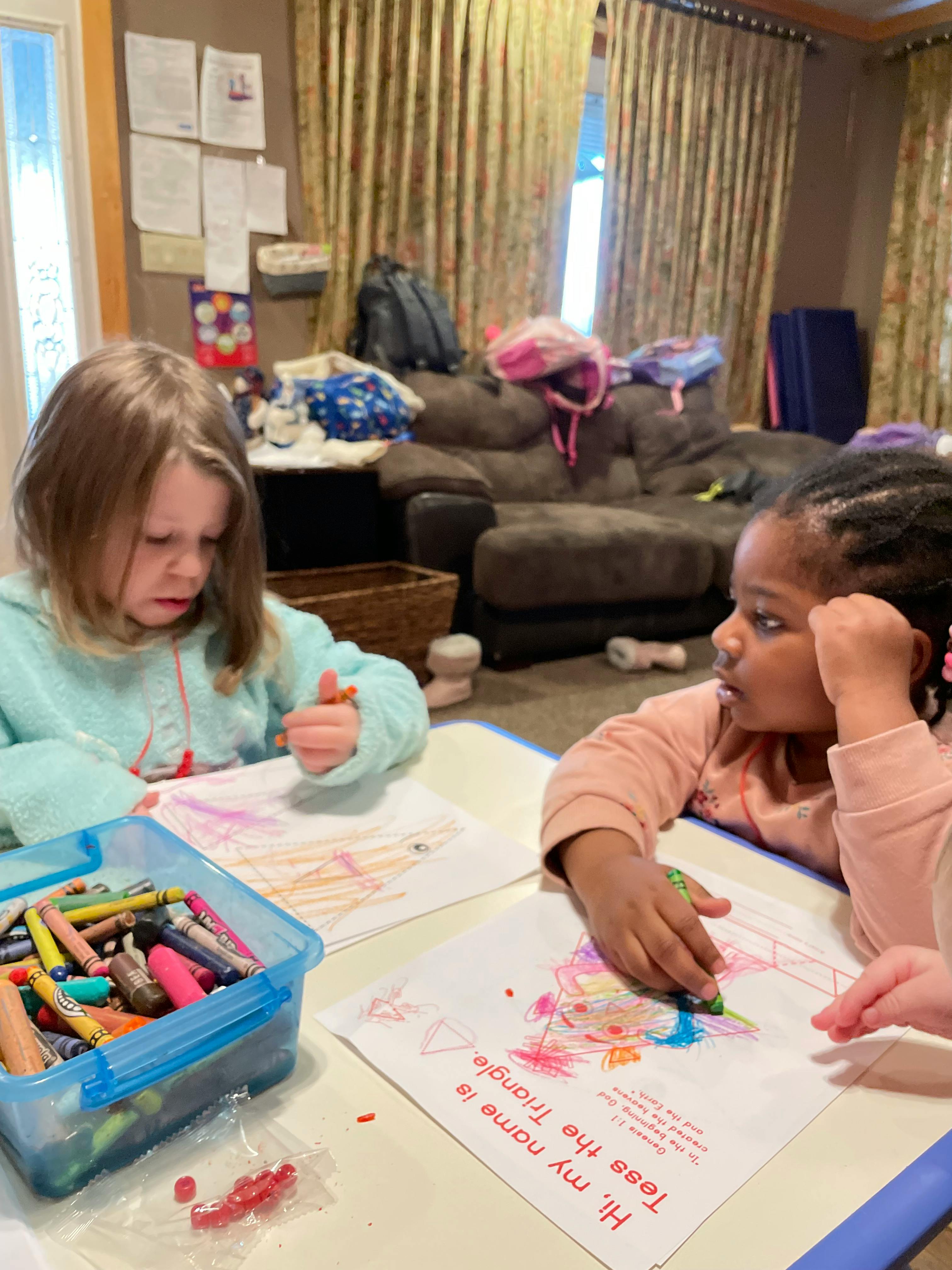 Two children coloring at a table