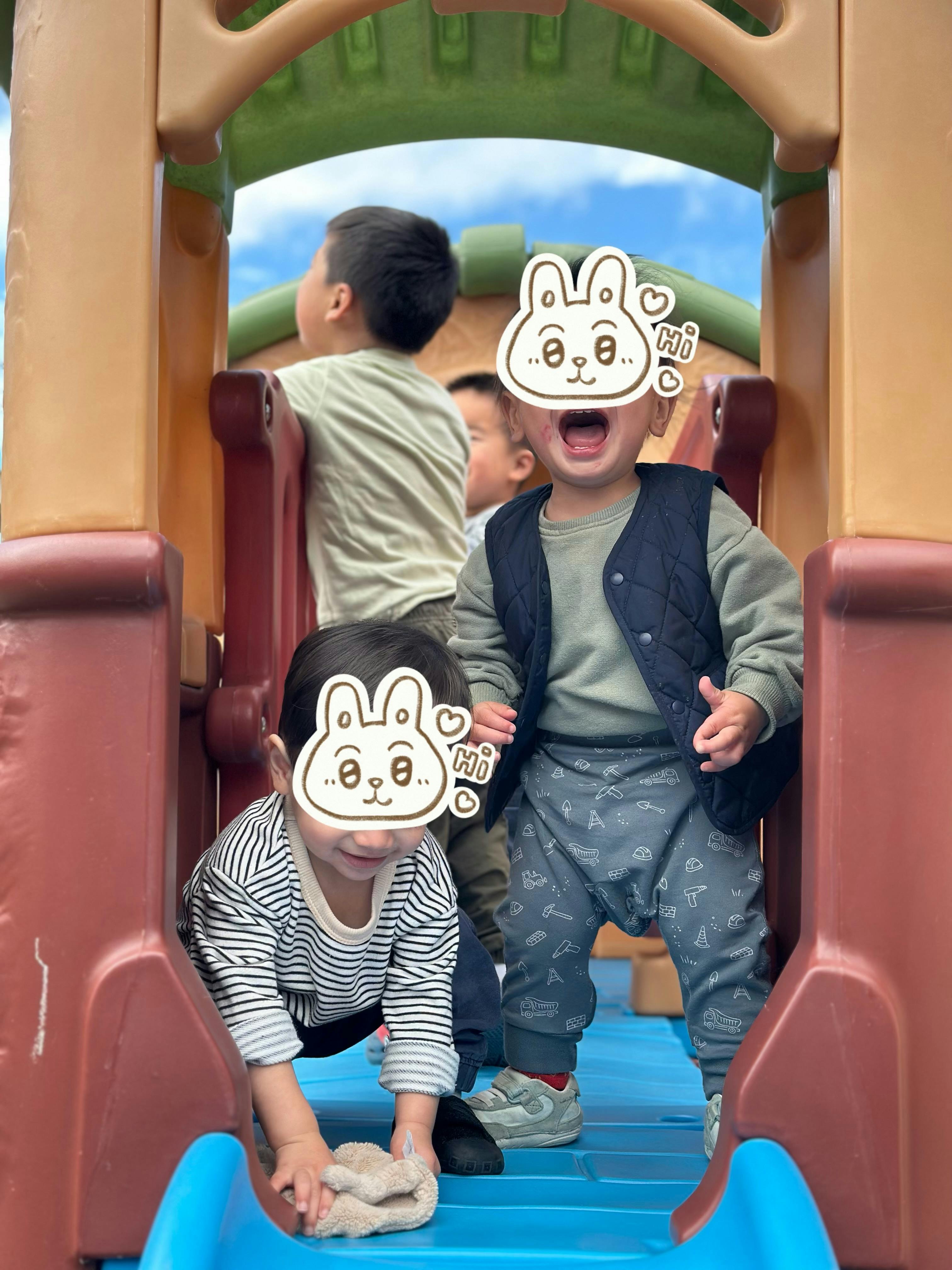 Children playing on a colorful playground structure