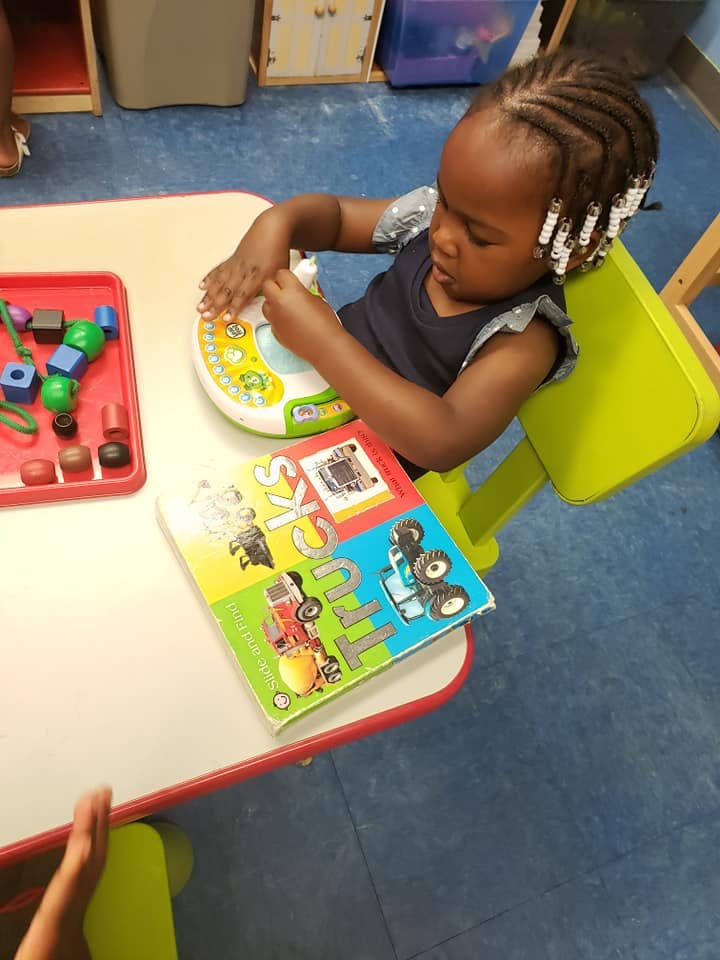 Child playing with a toy at a table