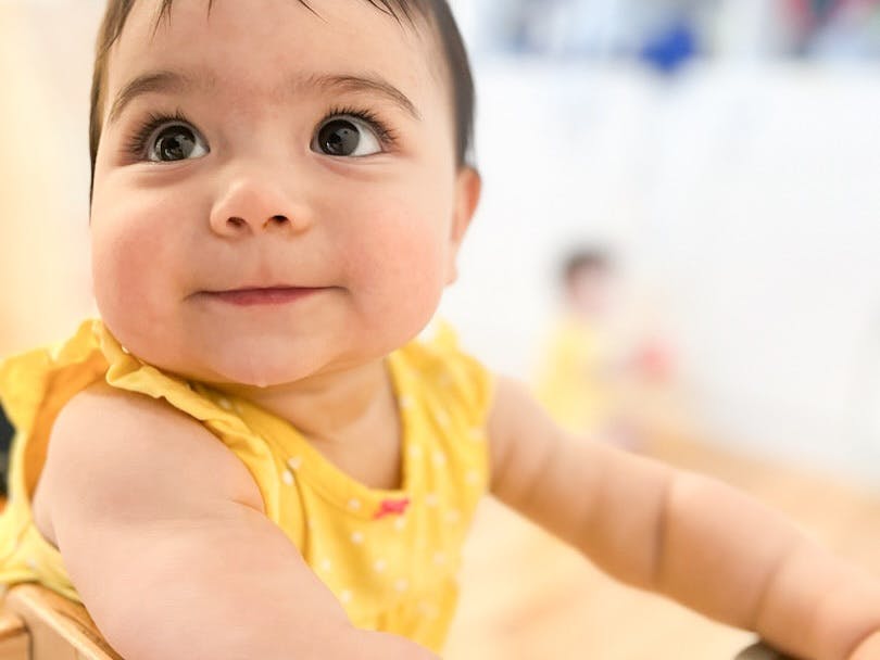 Child in a yellow top looking up