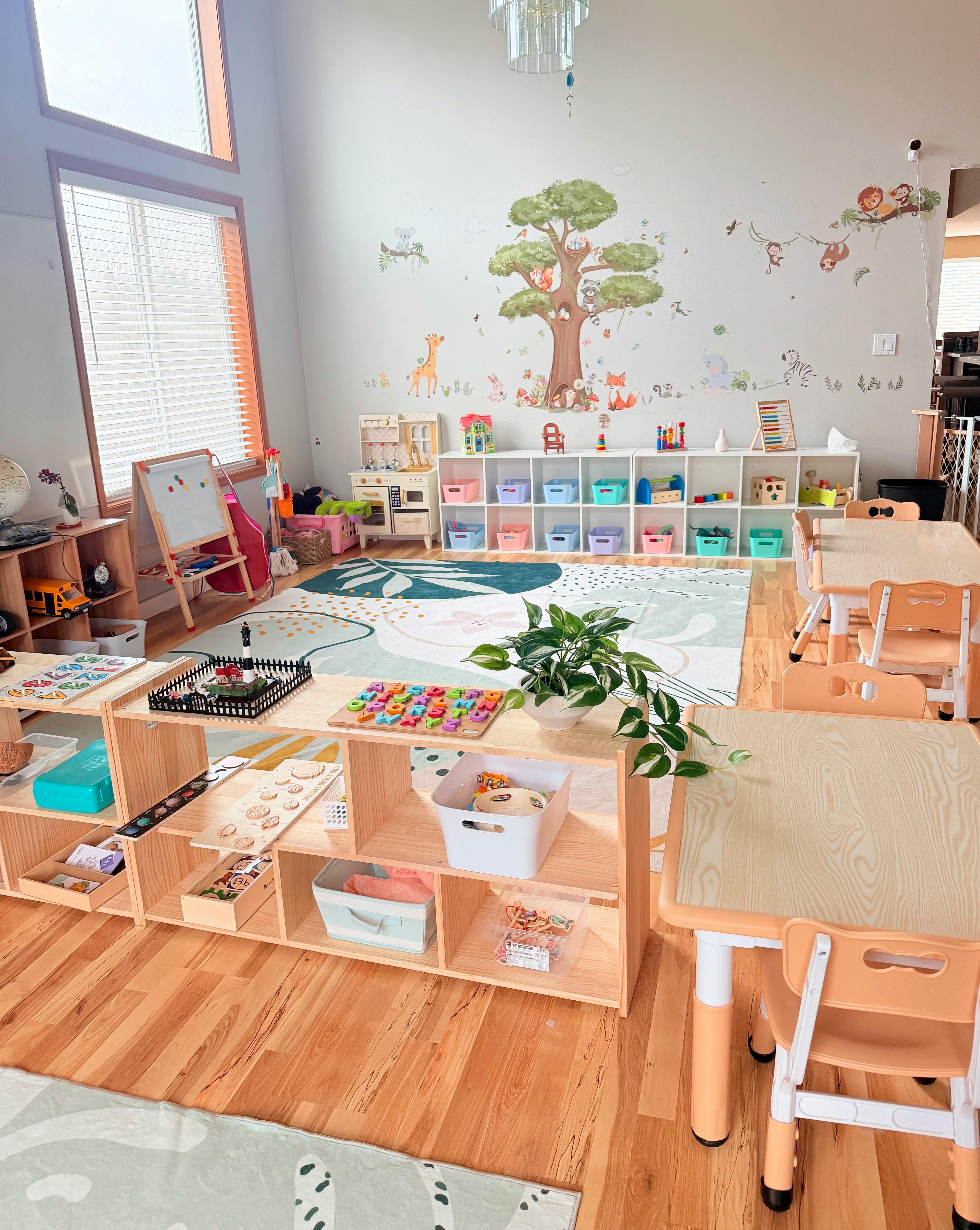 A colorful classroom with child-sized tables, shelves of toys, and animal wall decals