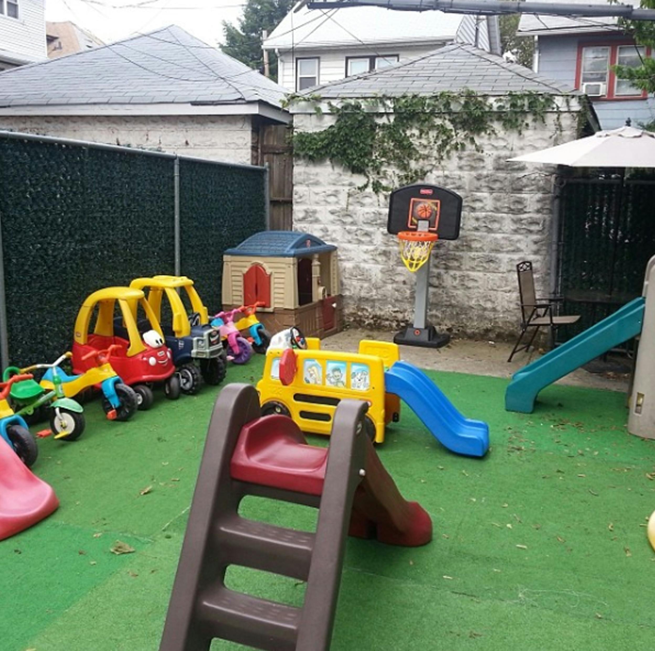 Outdoor play area with various colorful plastic toys and slides