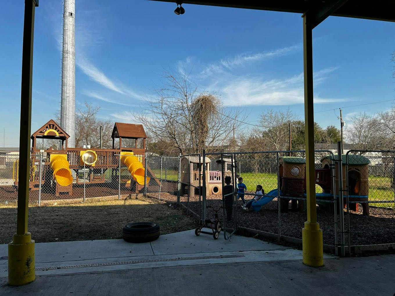 Children playing on a playground with slides and play structures