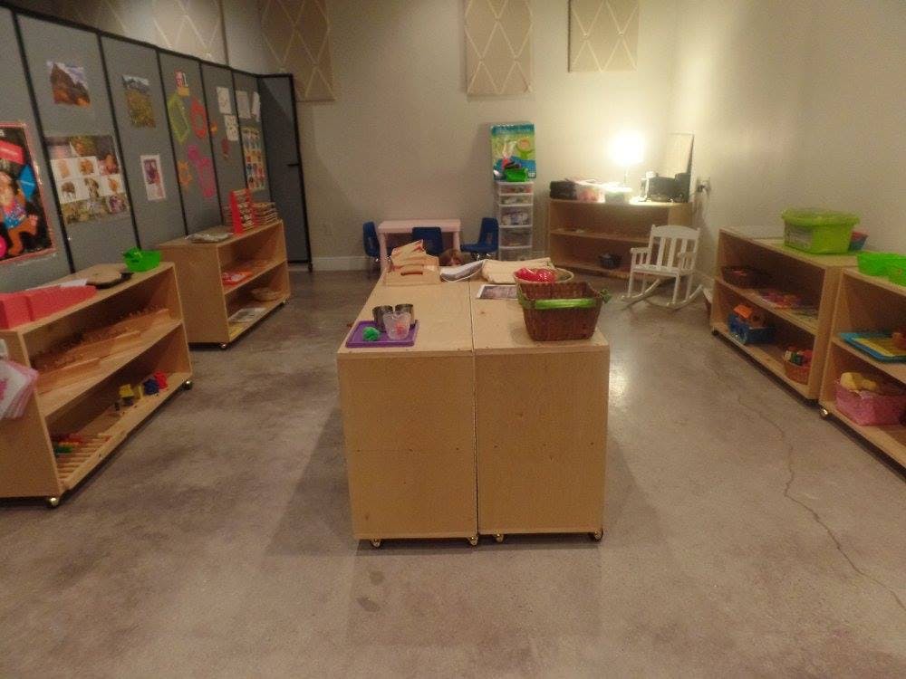 Classroom with tables, shelves, and room dividers