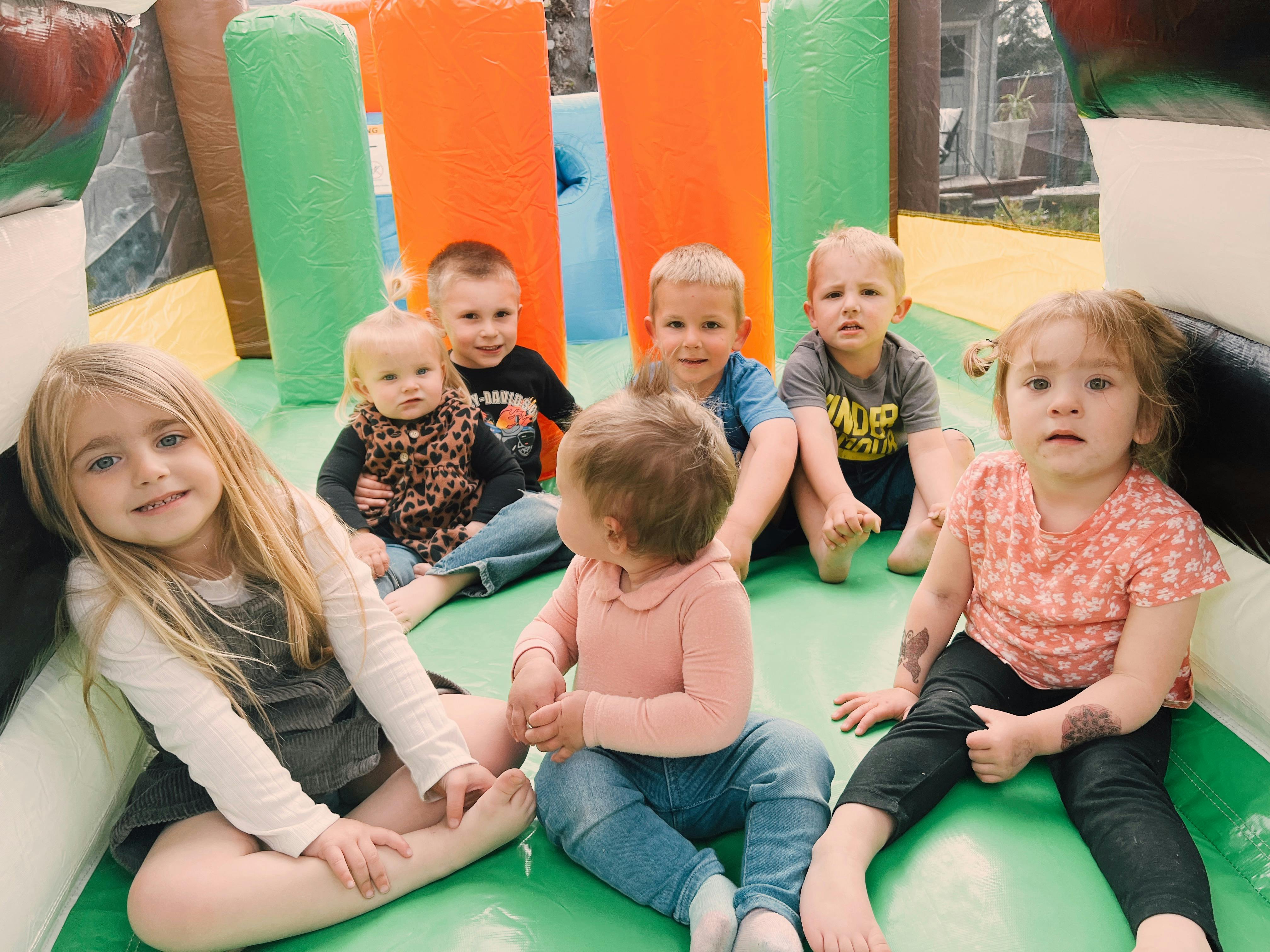 Group of children sitting on an inflatable play structure