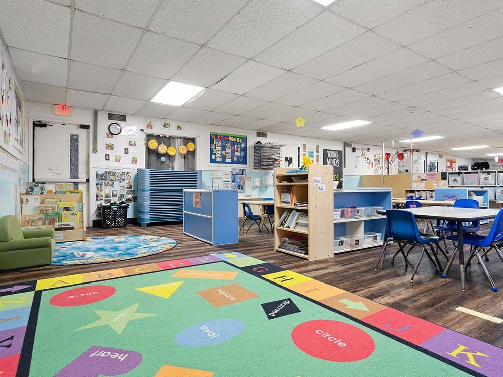 Classroom with colorful rug with shapes and letters