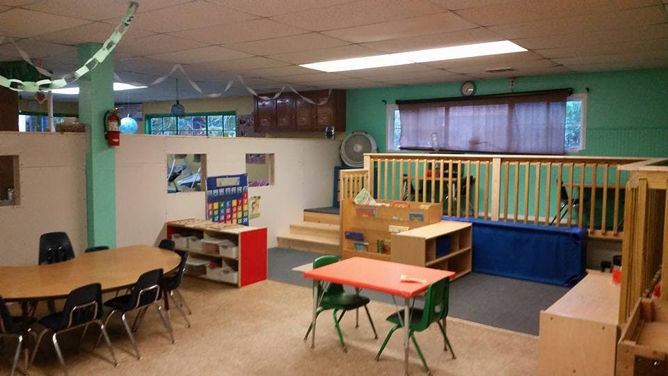 Classroom with tables, chairs, and play area