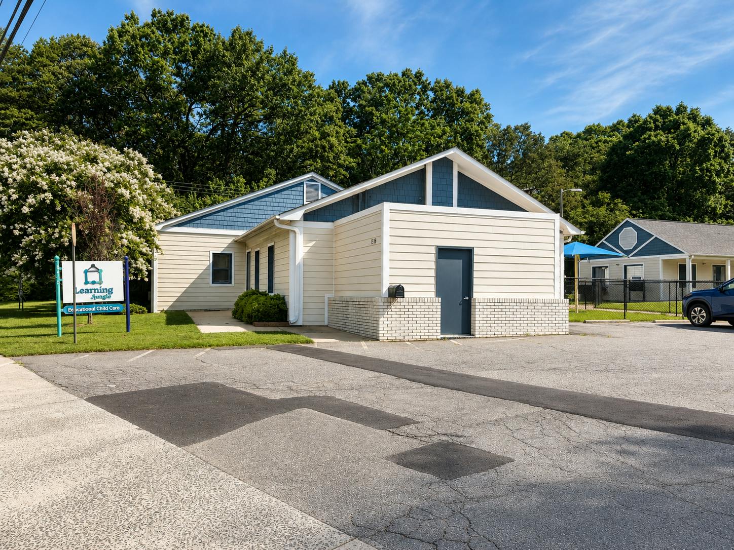 Learning Jungle child care center building with a parking lot