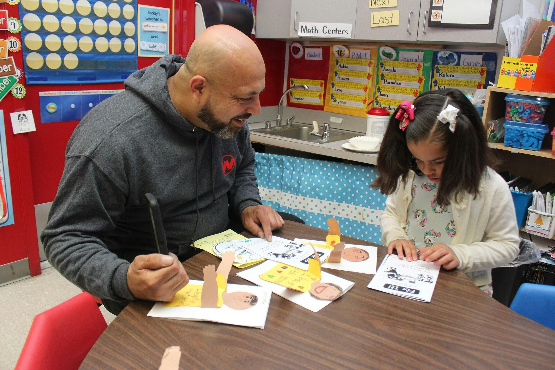 Adult and child doing an art activity at a table