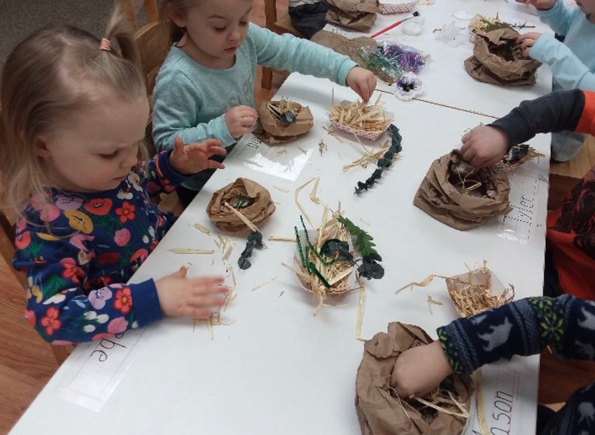 Children making crafts at a table