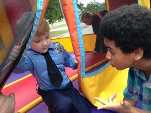 Child in police uniform talking to a teen