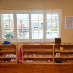 Montessori classroom with wooden shelves and learning materials
