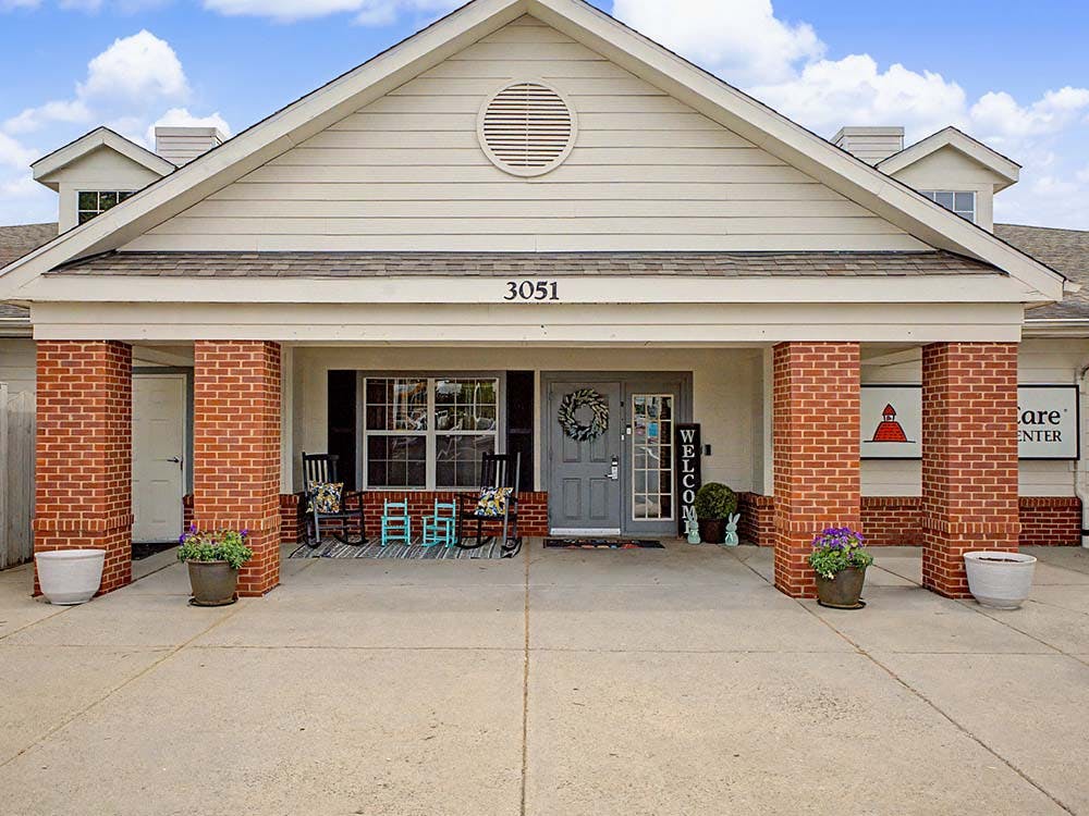 Entrance of a building with brick columns and "WELCOME" sign