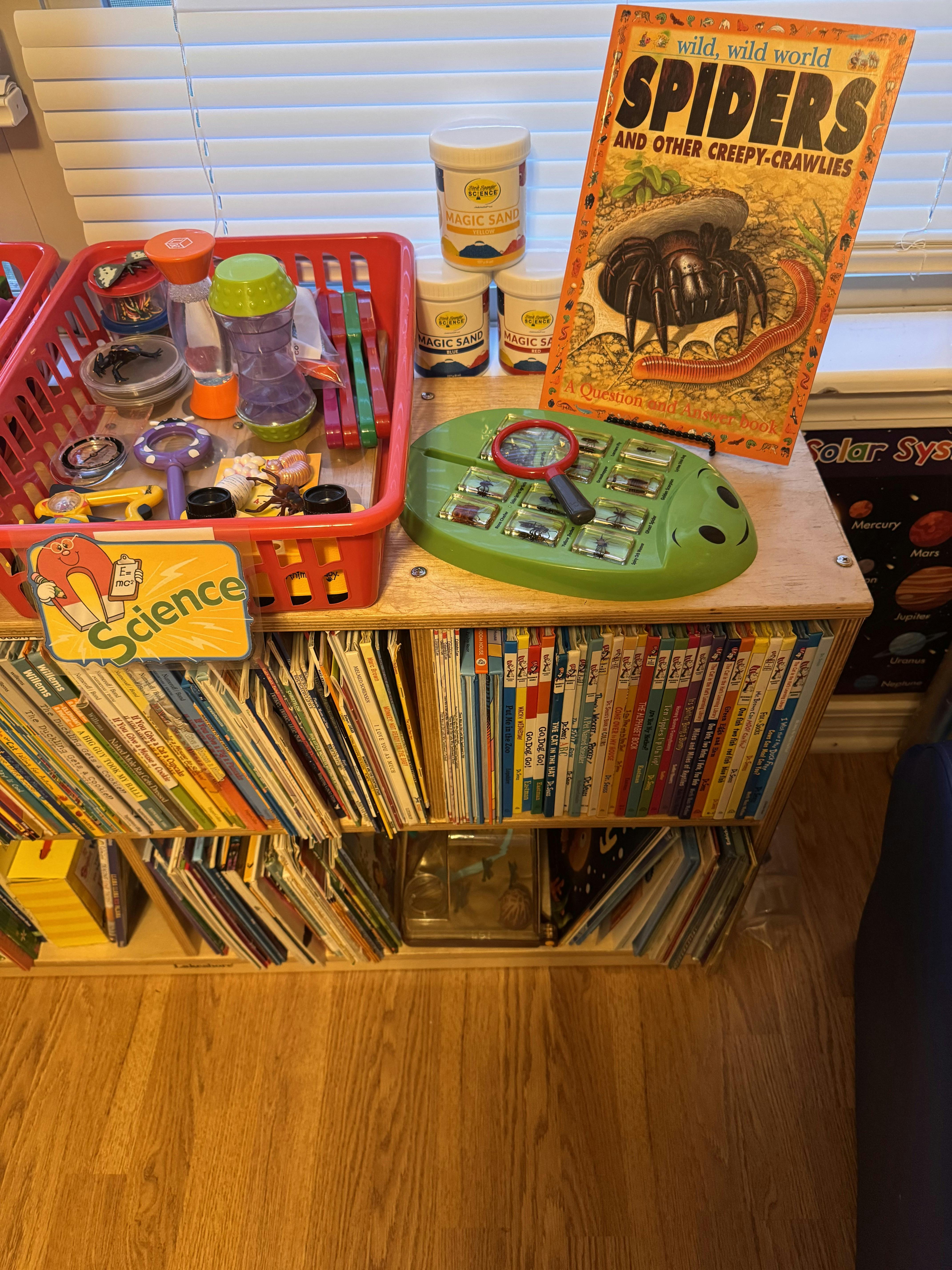 Science activity shelf with books and observation tools