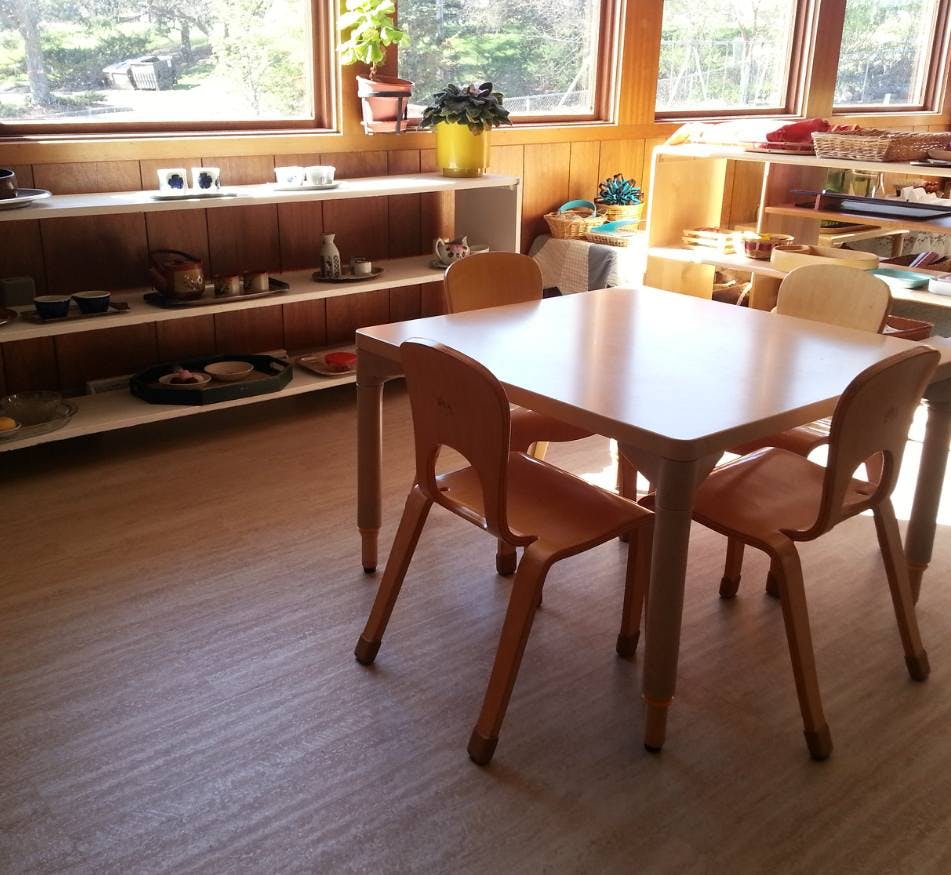 Small wooden table with four chairs in a classroom
