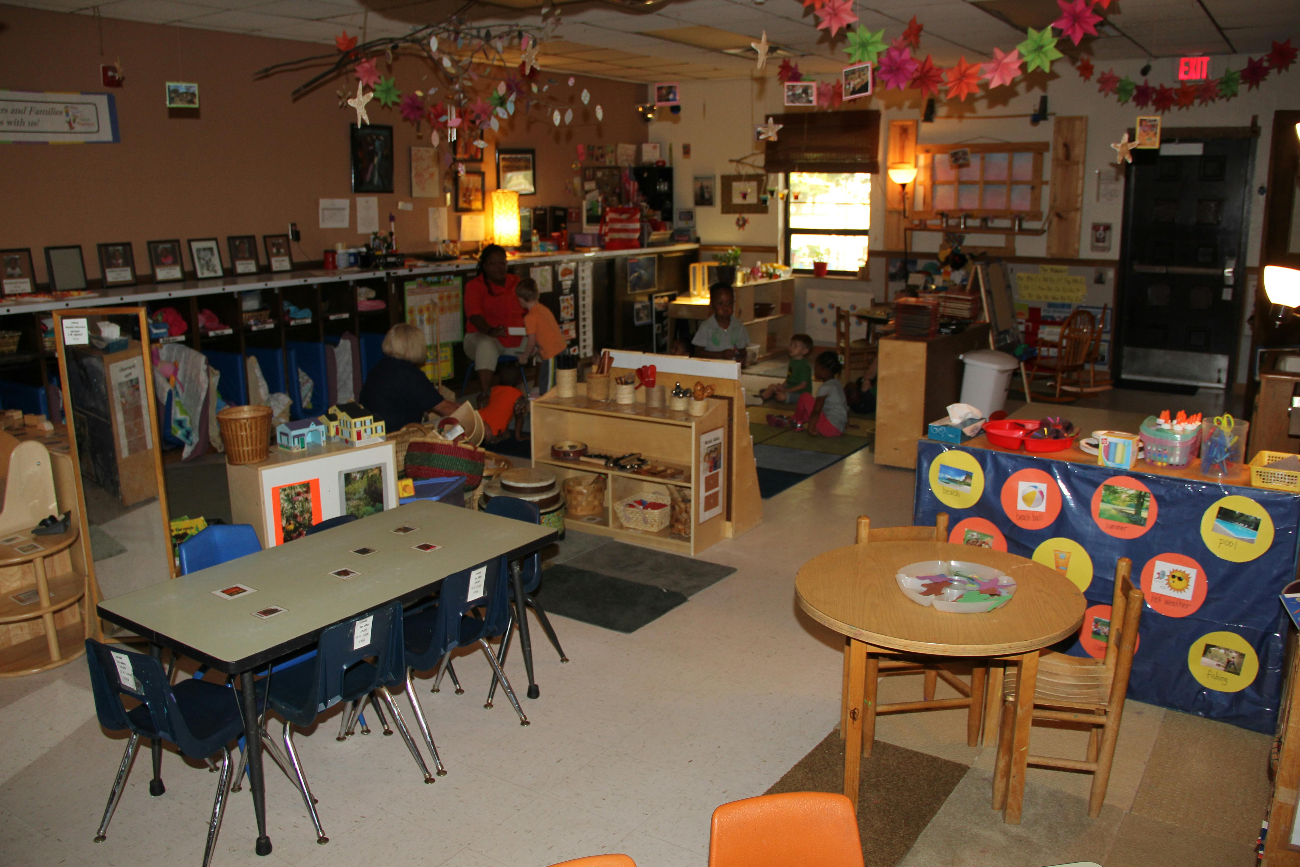 Classroom with tables and chairs, decorated with colorful garlands