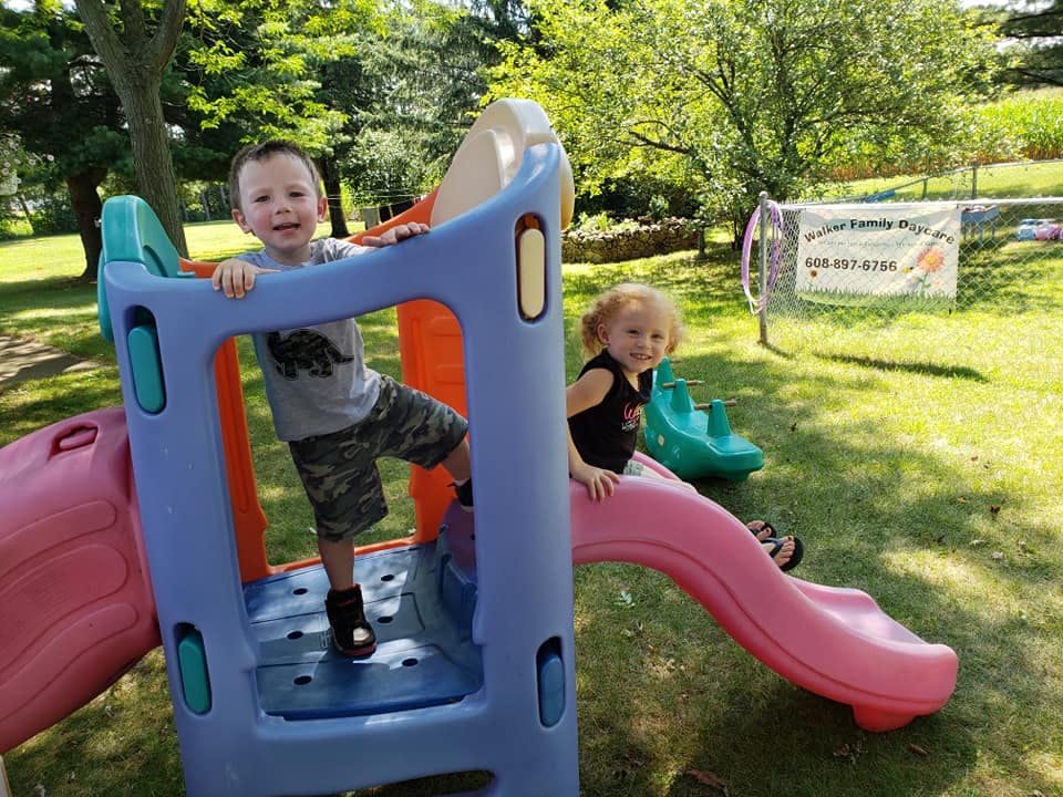 Two children on a playground slide structure