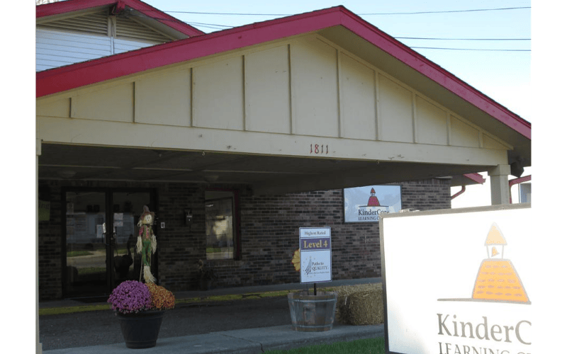 Entrance to a KinderCare Learning Center with signs and autumn decorations