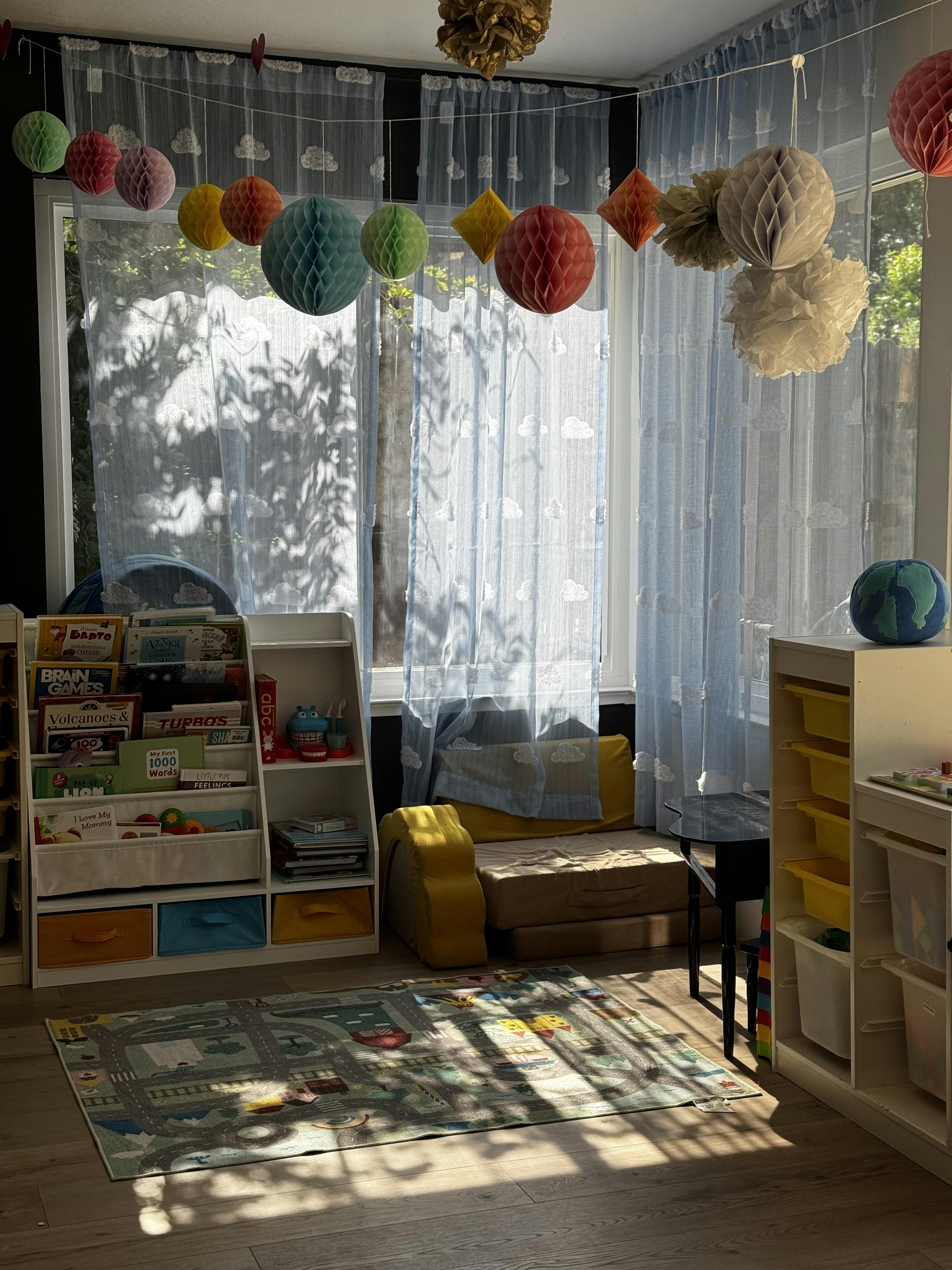 Children's room with bookshelves, play mat, and colorful decorations