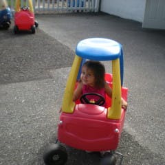 Child in a toy car