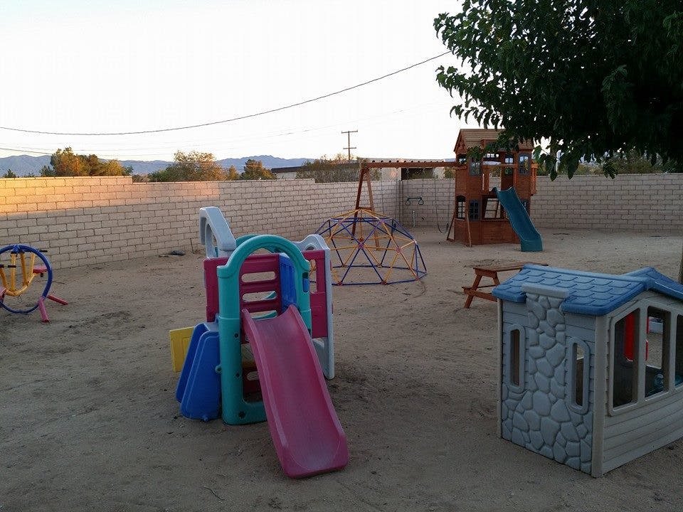Playground with slides, playhouse, and climbing dome