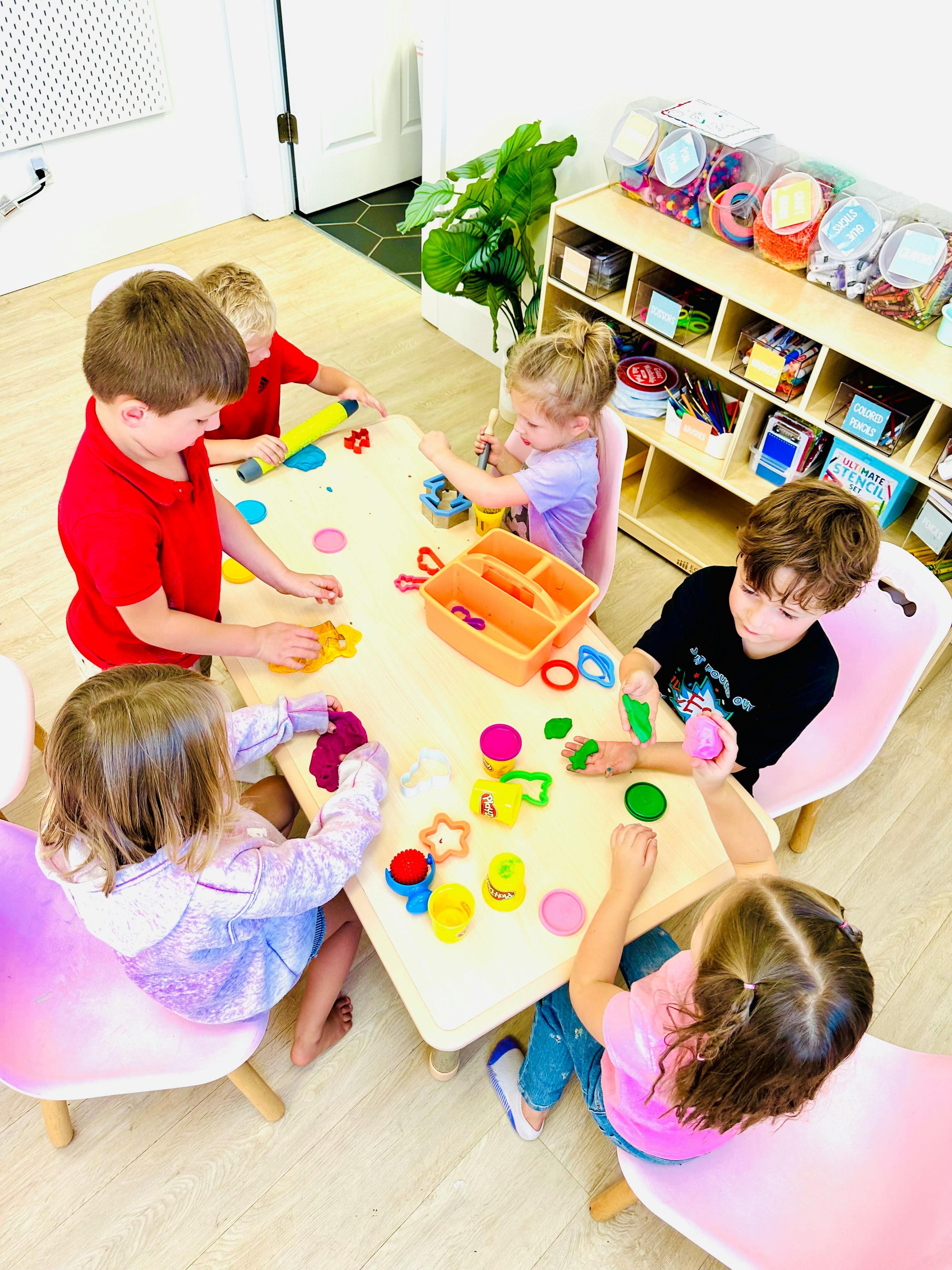 Children playing with modeling clay at a table