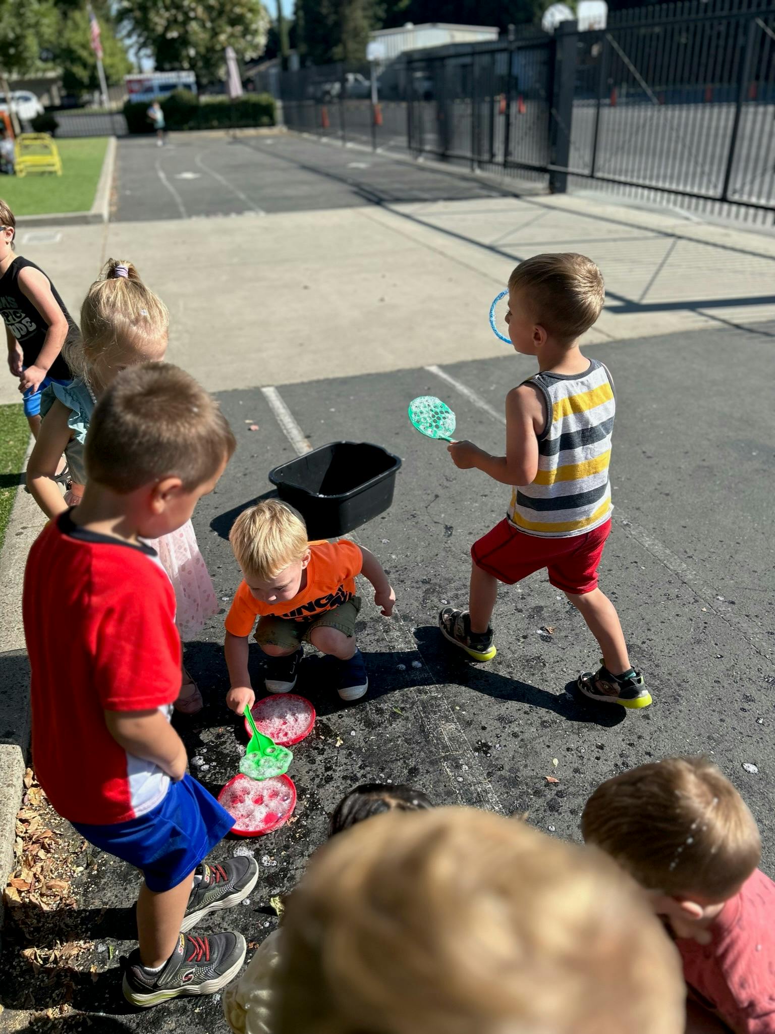 Children playing with bubbles outdoors