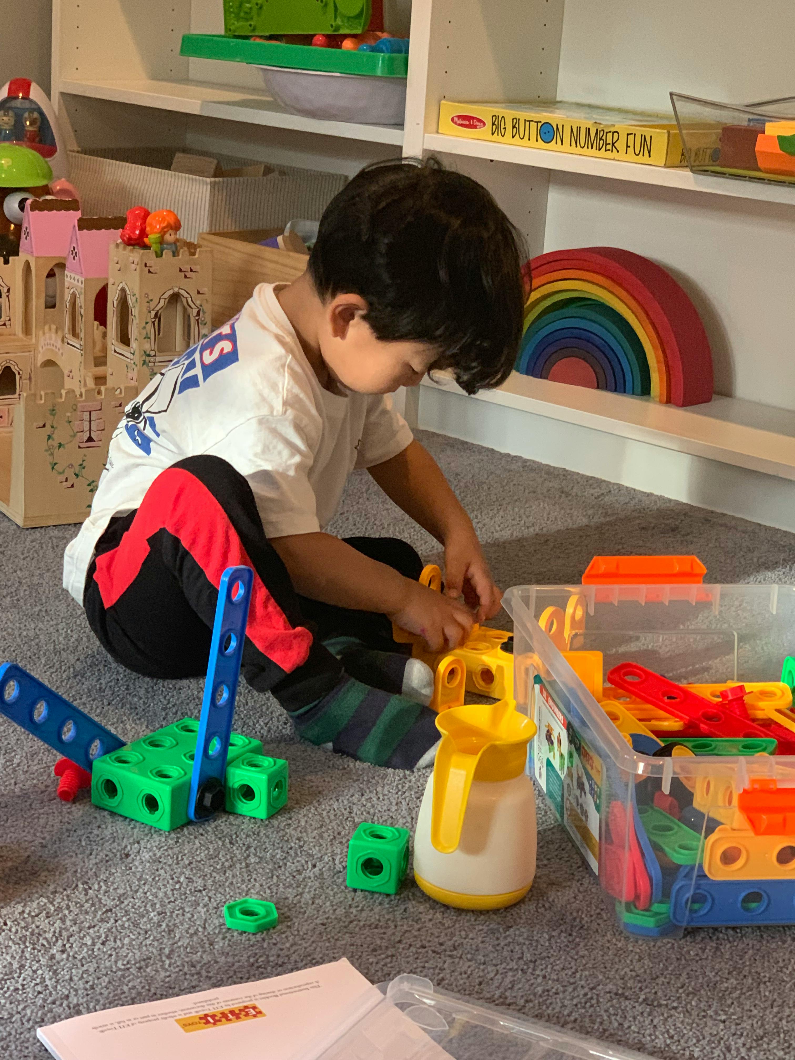Child playing with building blocks on the floor