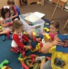 Children playing with blocks on the floor