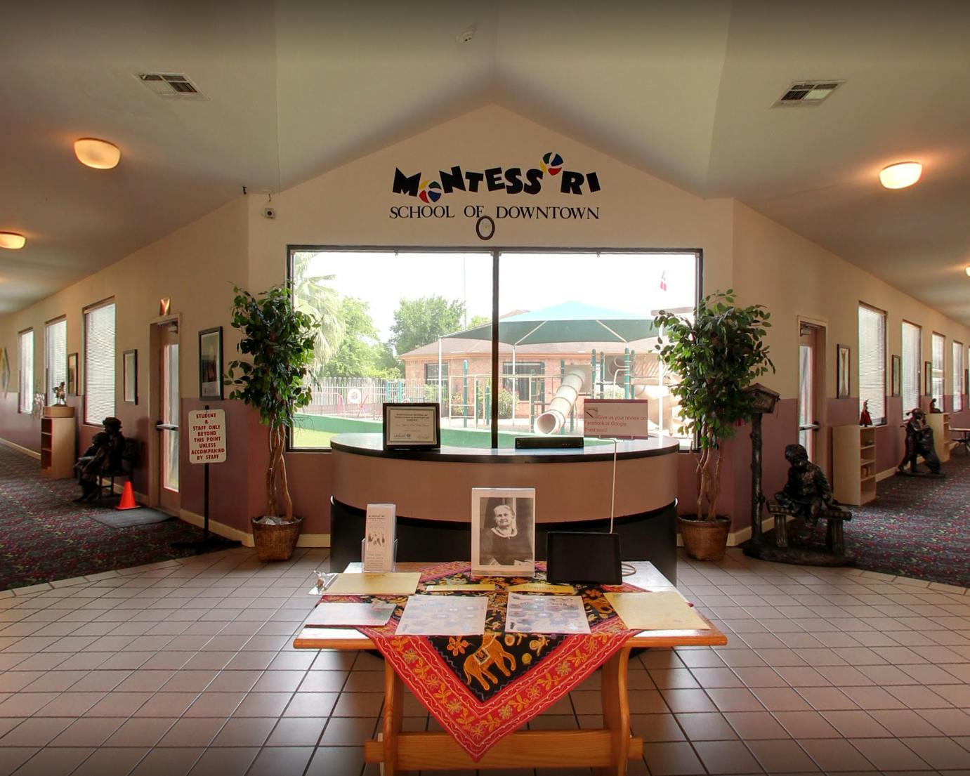 Montessori School of Downtown sign above a reception desk and large window