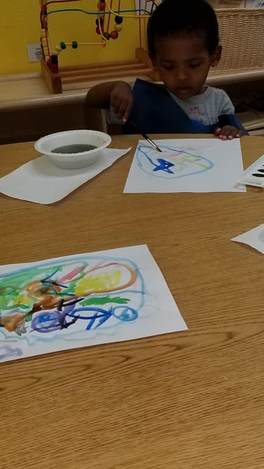 Child painting at a table