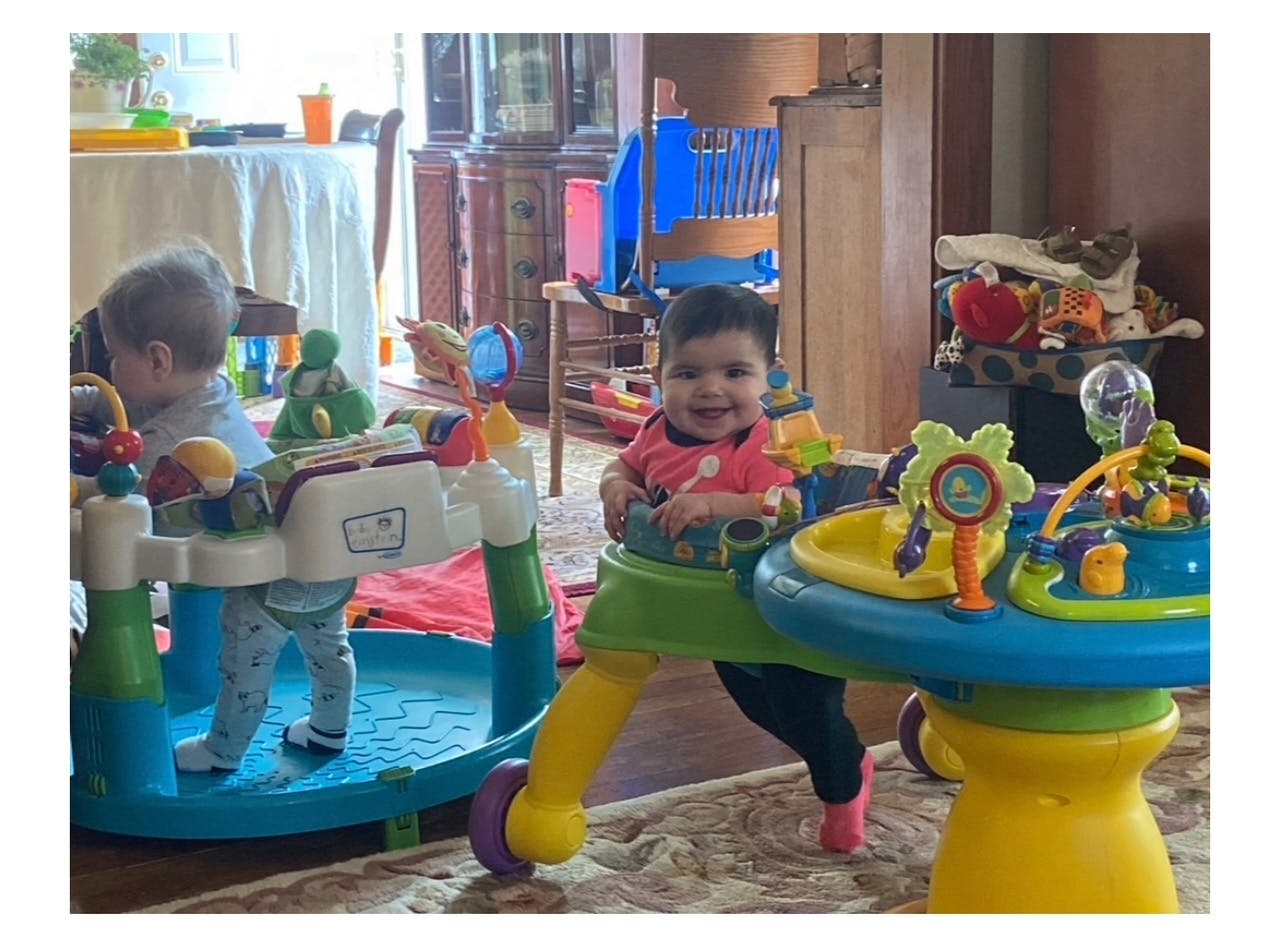 Two children in baby activity centers
