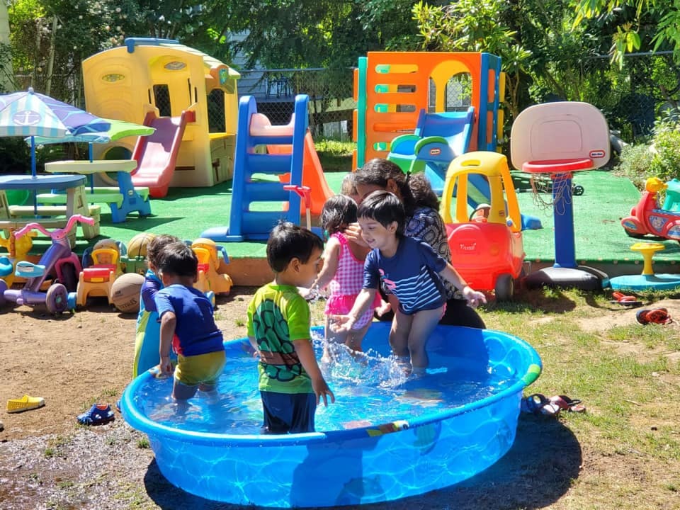 Children playing in a small pool at a playground