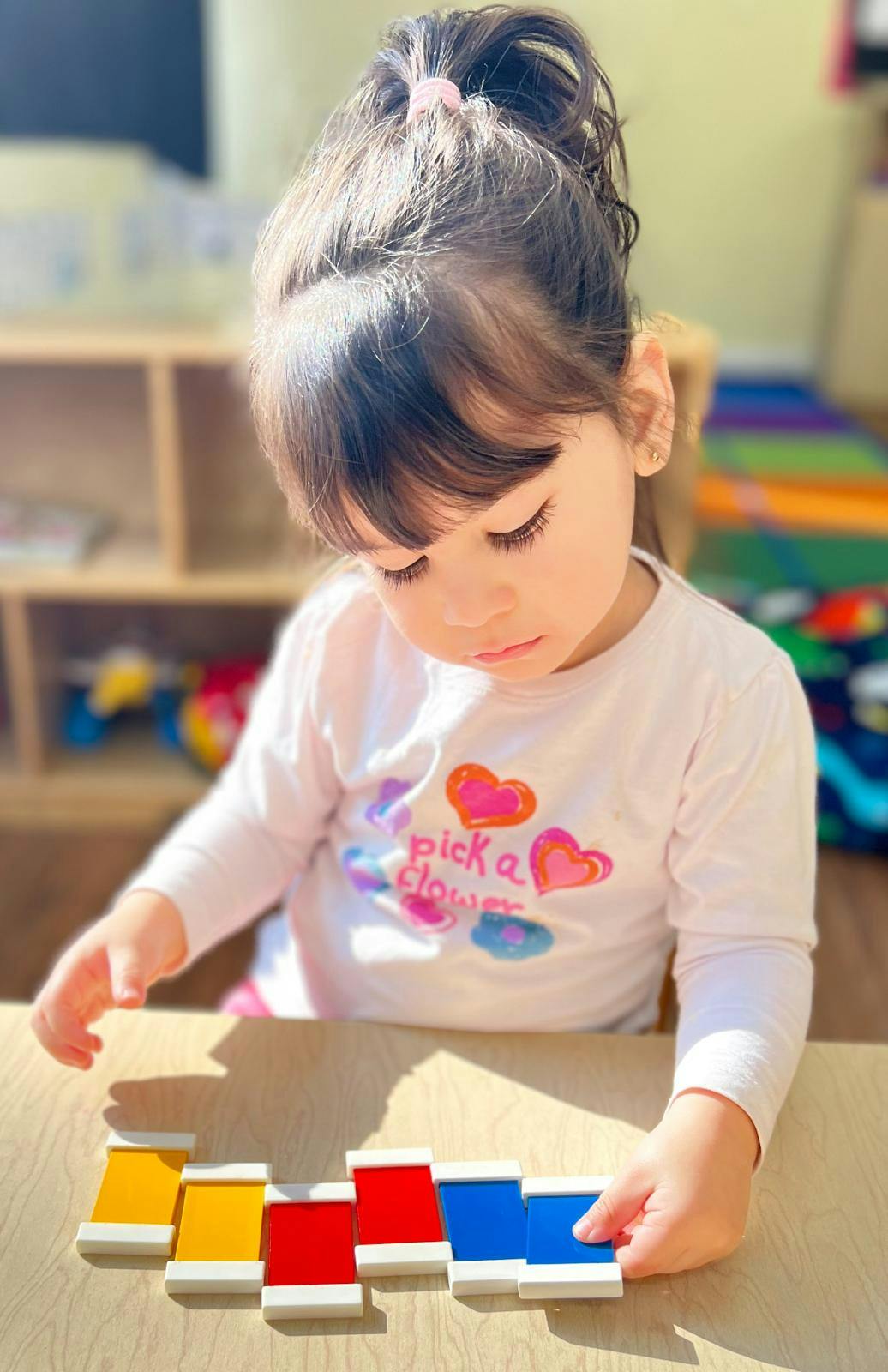 Child playing with colorful blocks on a table