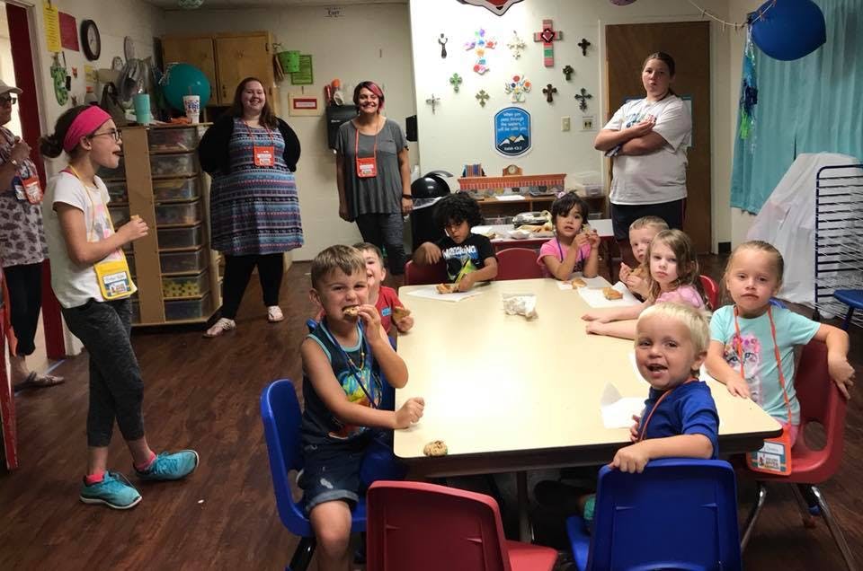Adults and children in a classroom