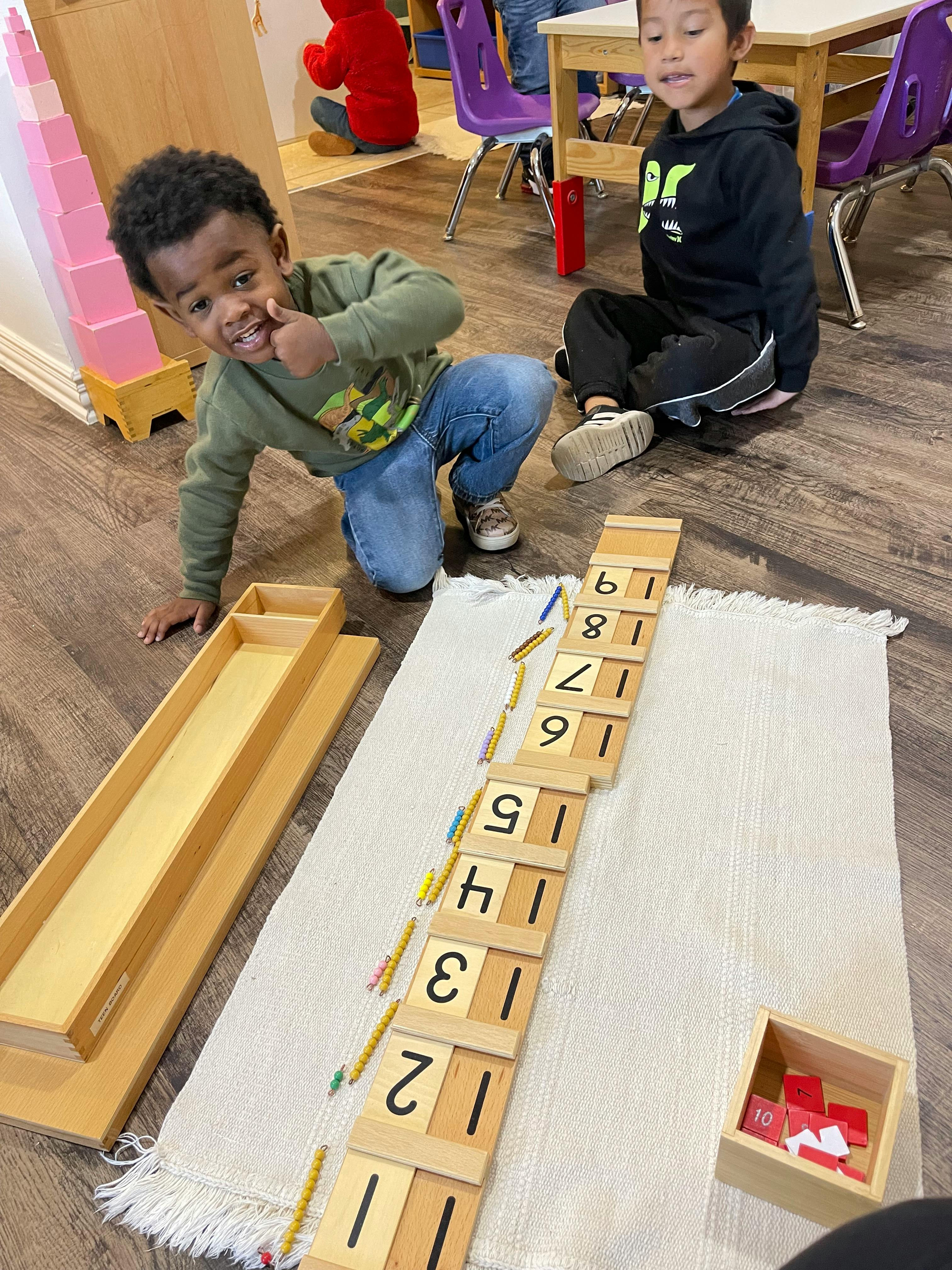 Two children on the floor with number blocks