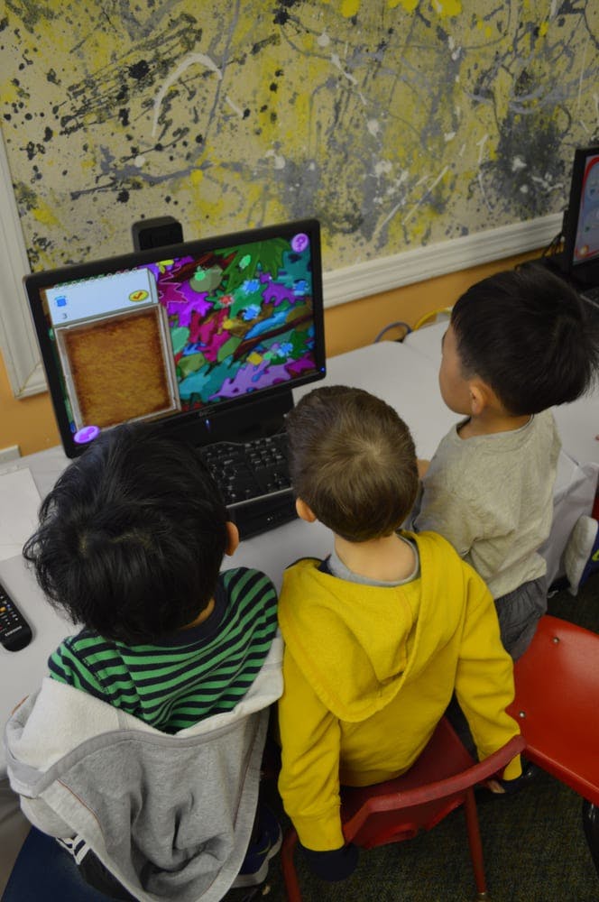 Three children looking at a computer screen