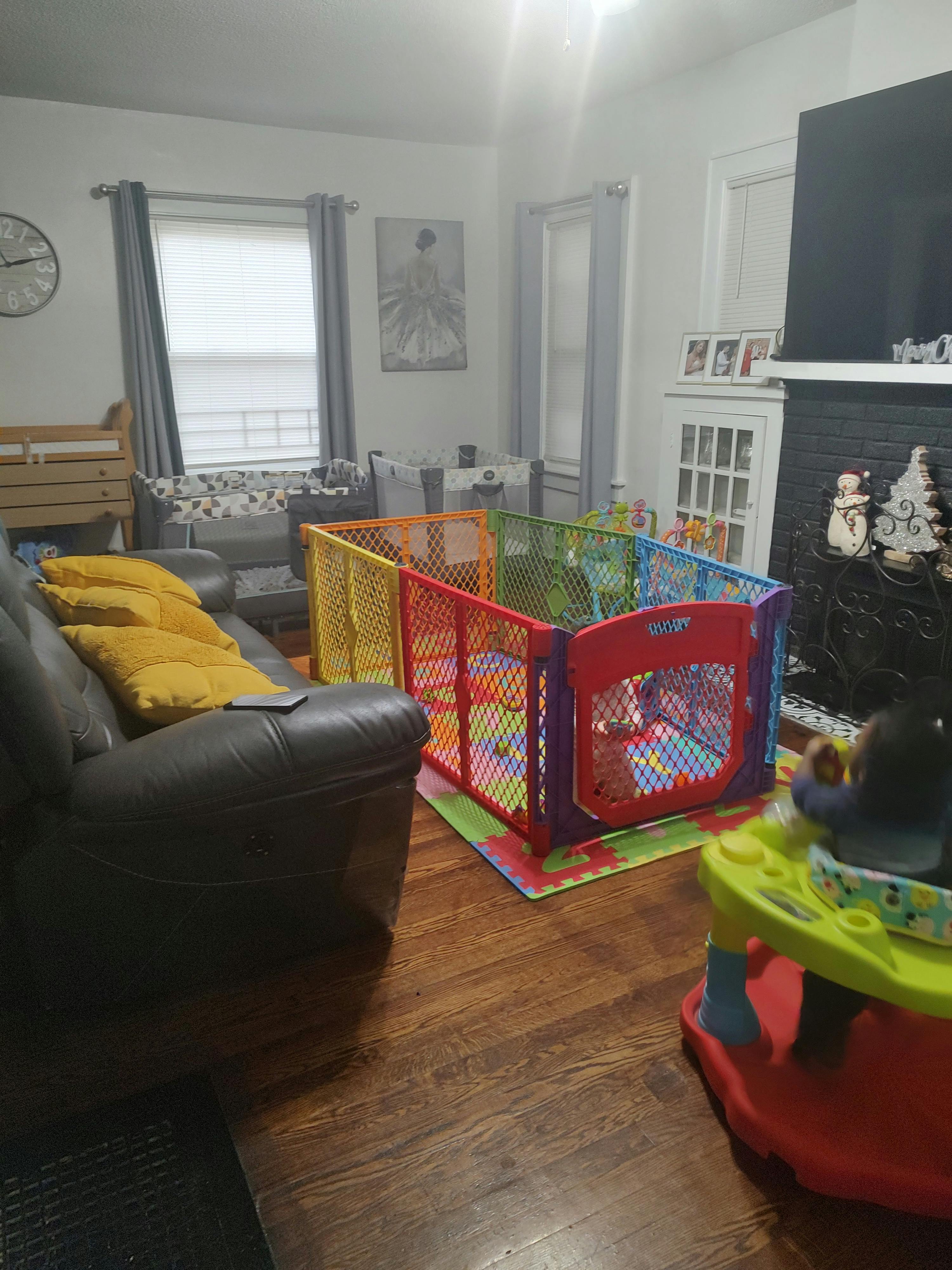Colorful playpen on a mat in a living room