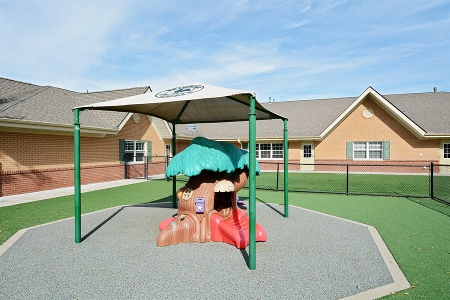 Playground with a small slide under a canopy