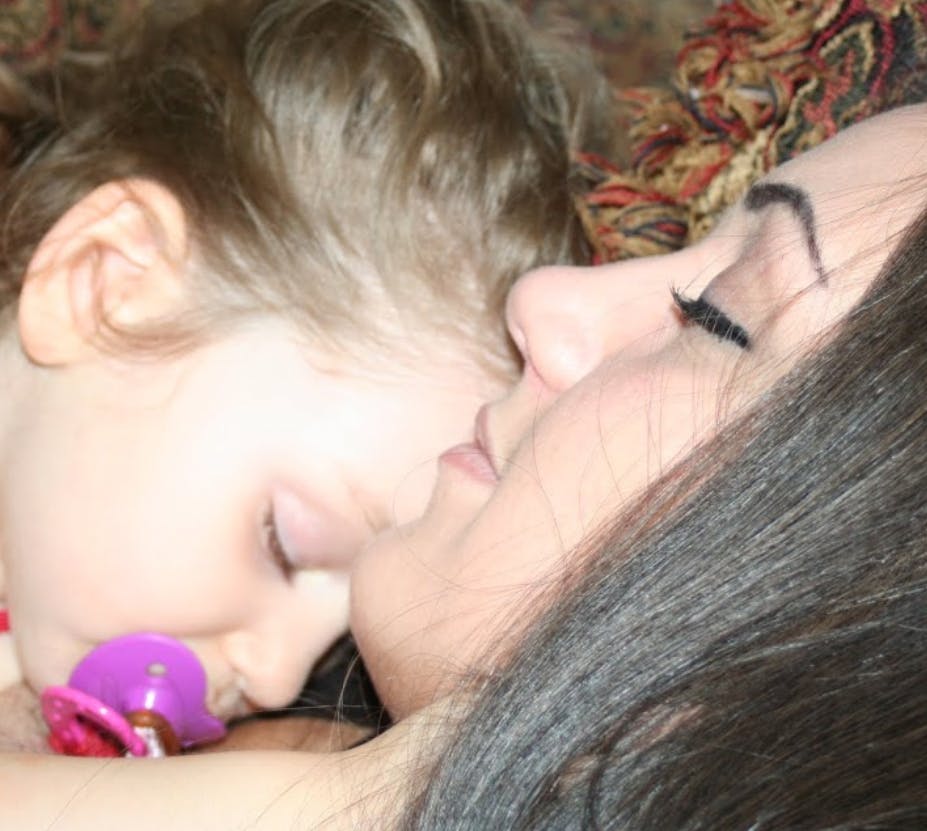 Person and child sleeping close together