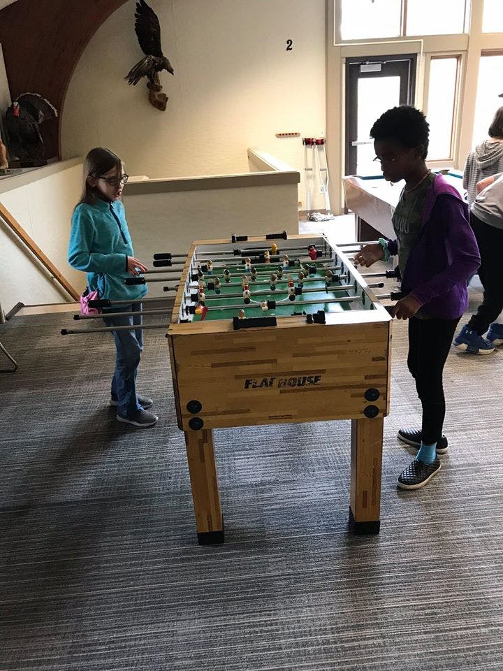 Two people playing foosball