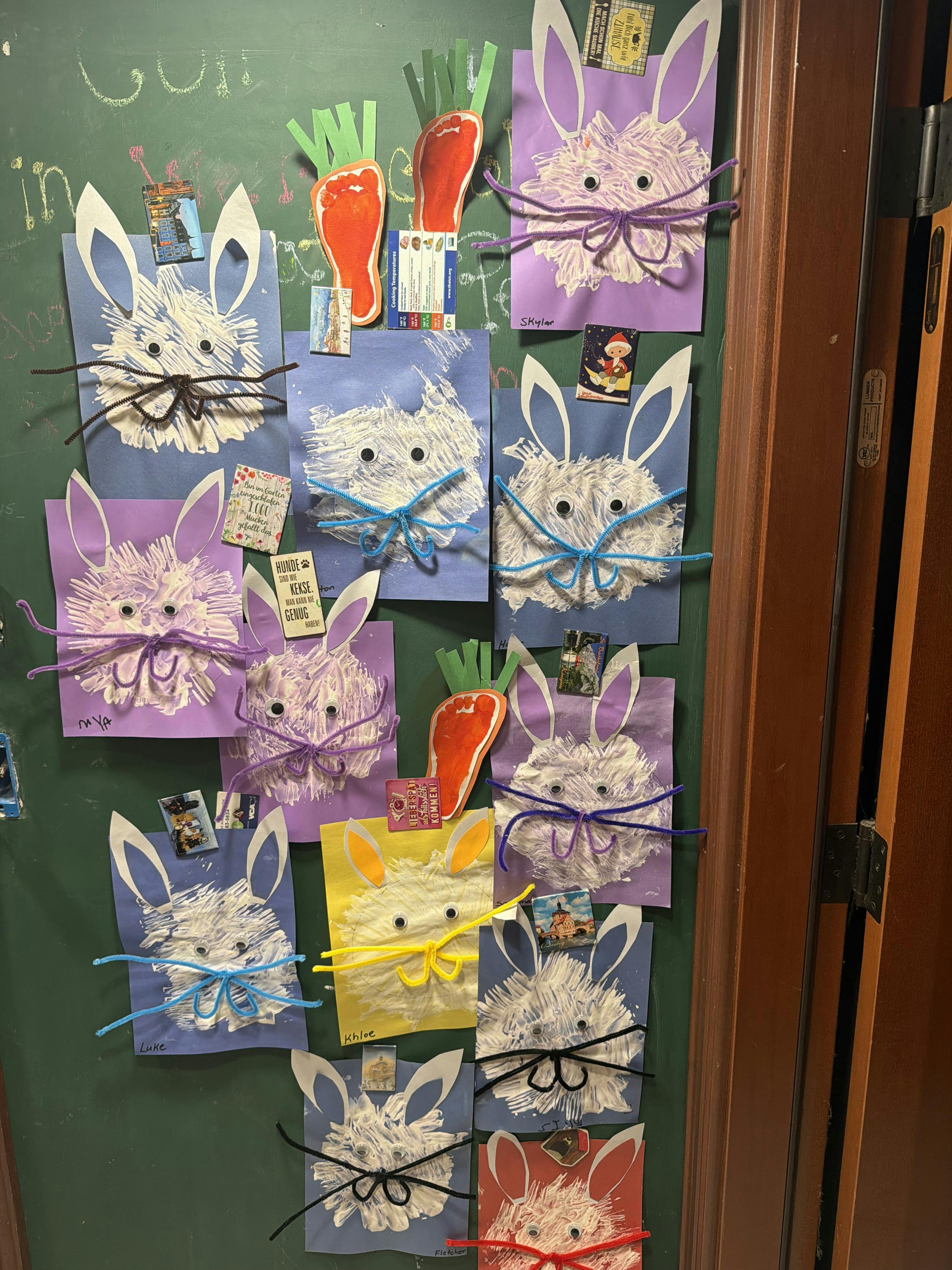 Handmade paper bunny crafts displayed on a chalkboard