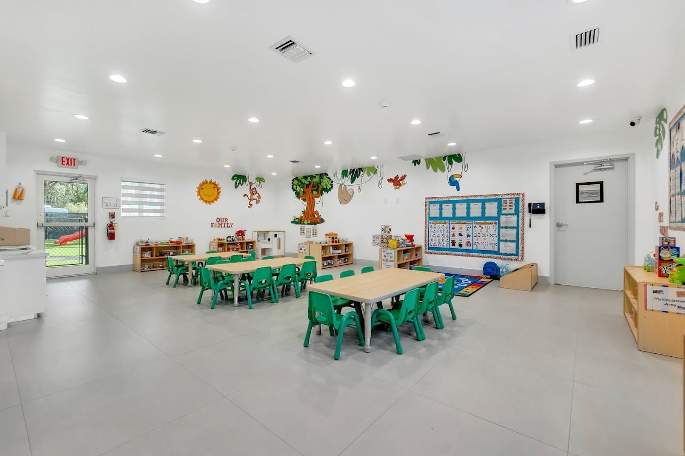 Classroom with small tables and chairs, colorful wall decorations