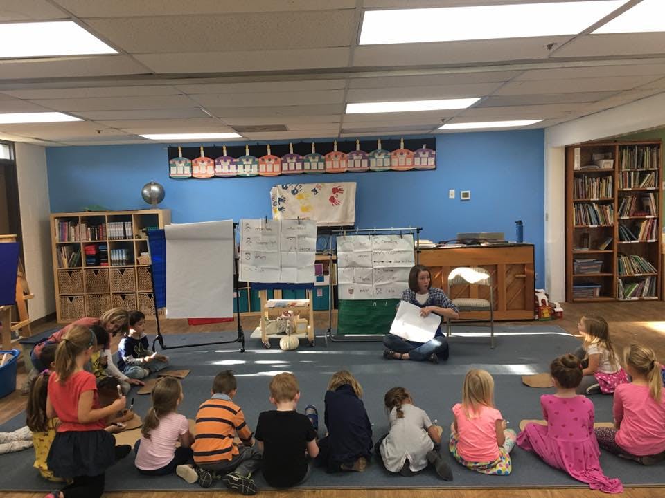 Person reading to children in a classroom